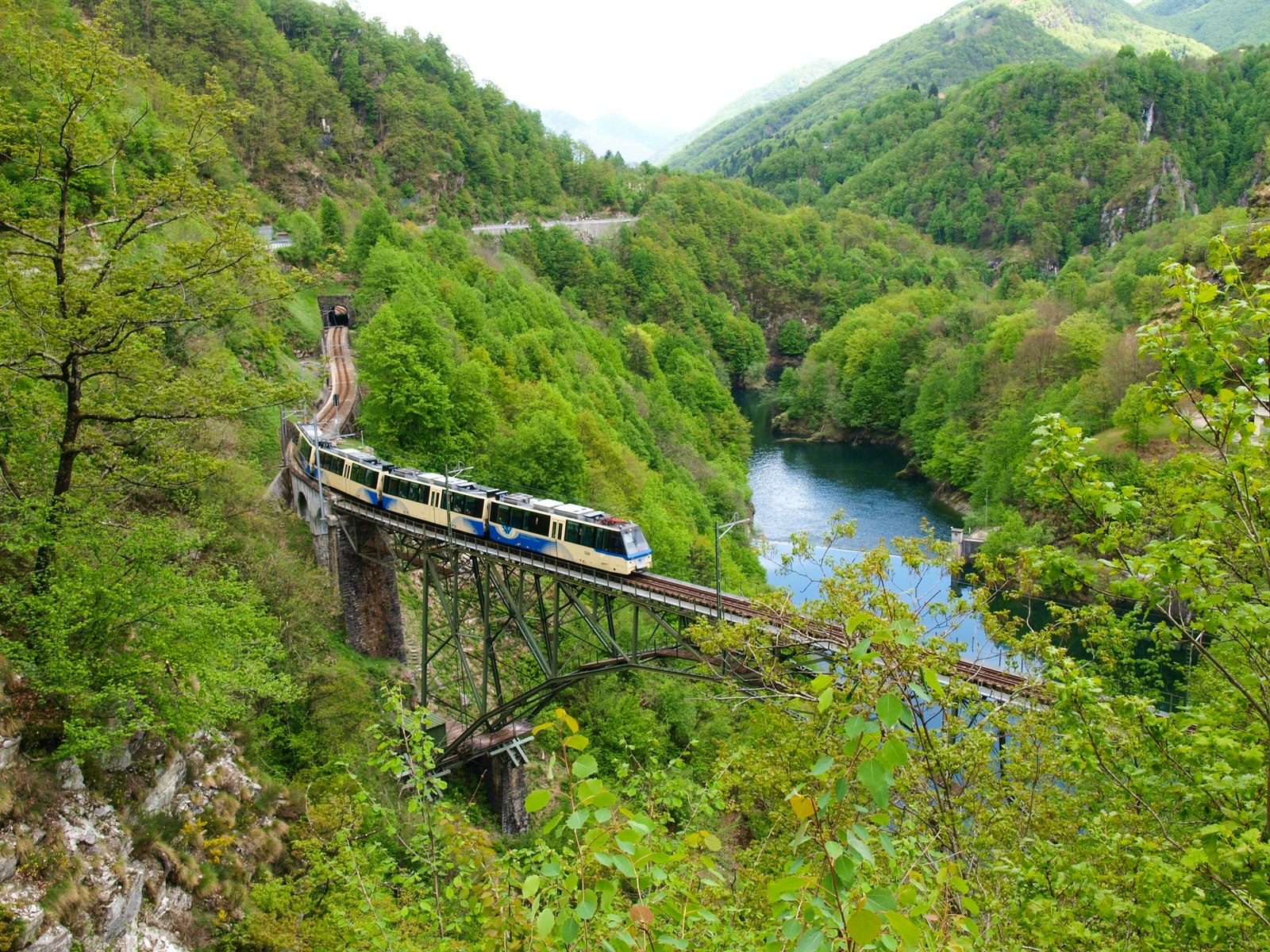 Train on the Centovalli Railway crosses the Isorno Bridge near Intragna, Switzerland
