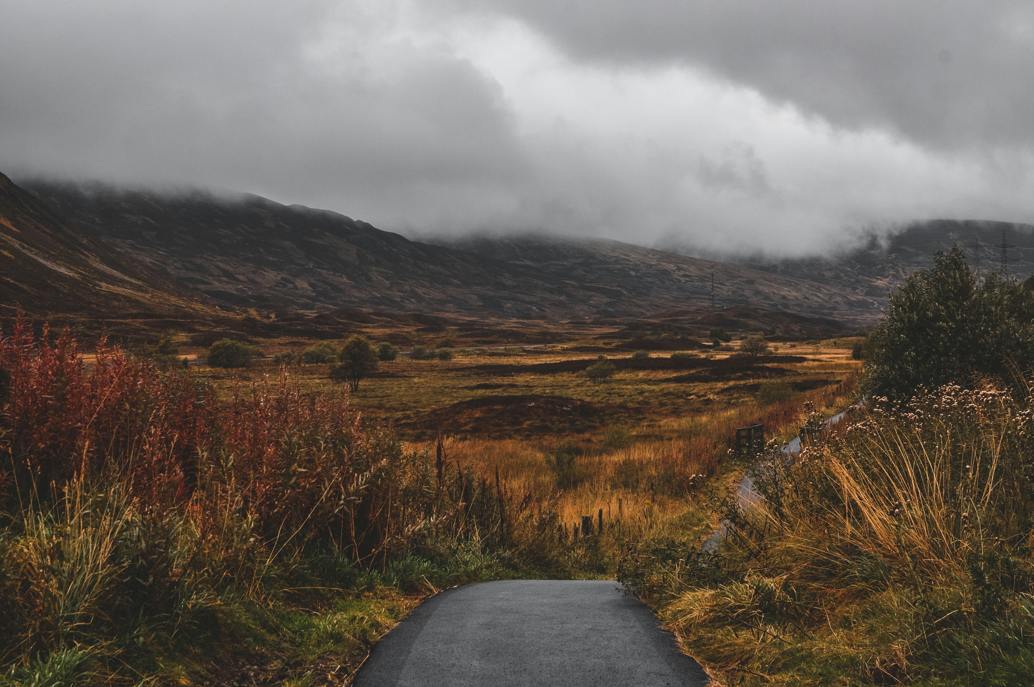 A path through the mountains of Skye. The clouds are grey and low, hiding the mountain.