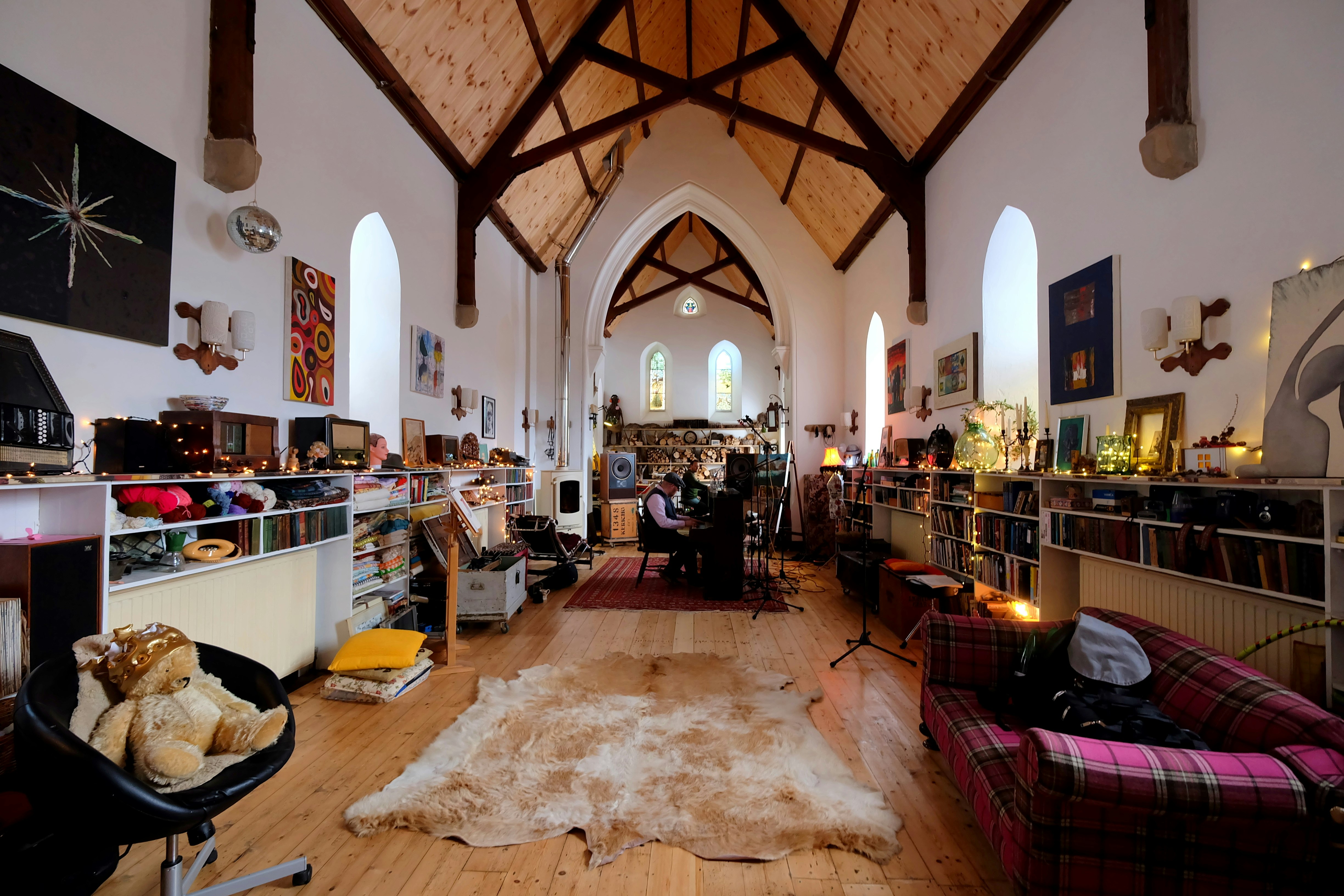 The interior of the converted St Mary's Church in Argyll; it has vaulted ceilings, and is kitted out with soft furnishings and recording equipment.