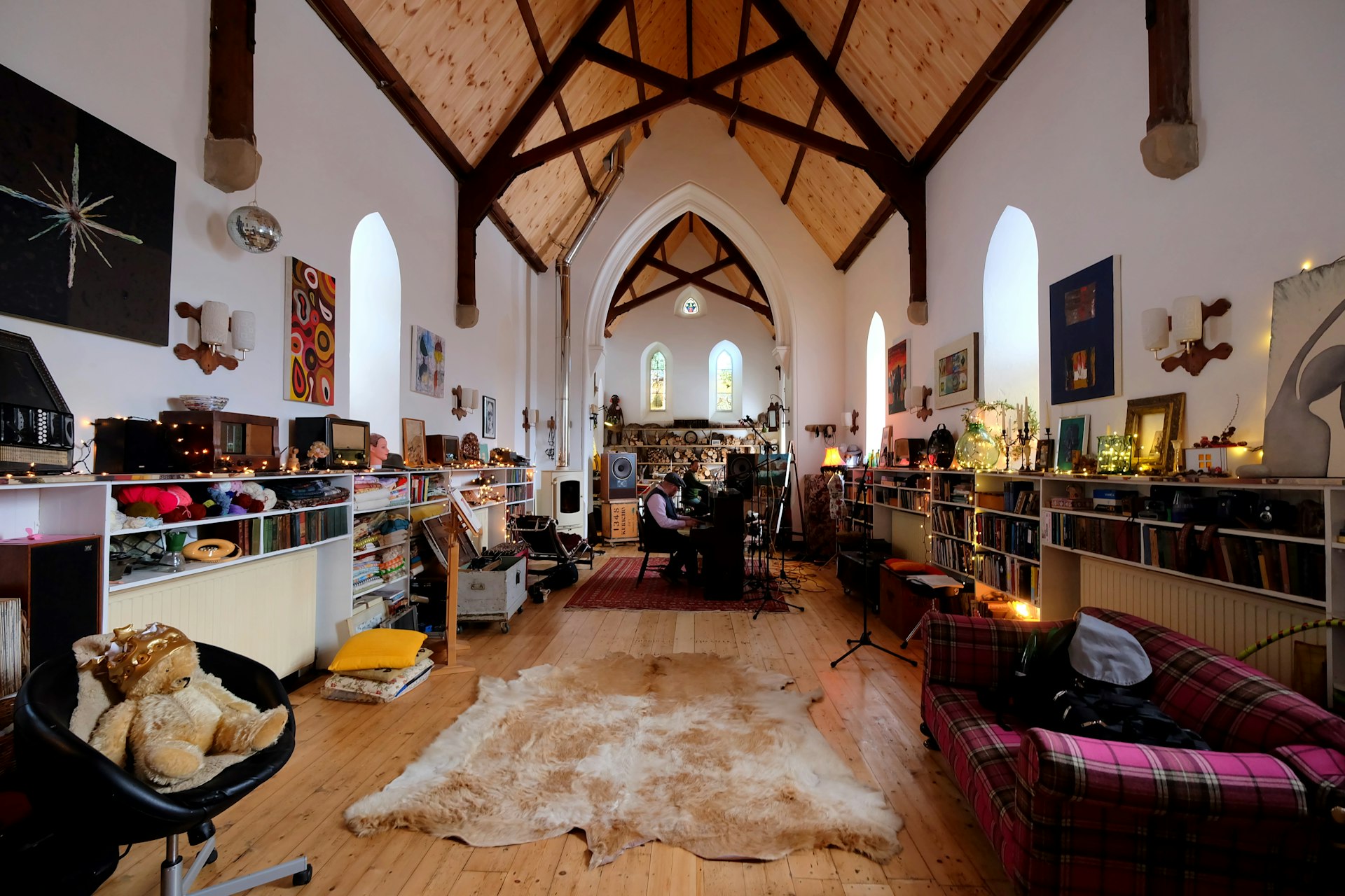 The interior of the converted St Mary's Church in Argyll; it has vaulted ceilings, and is kitted out with soft furnishings and recording equipment.