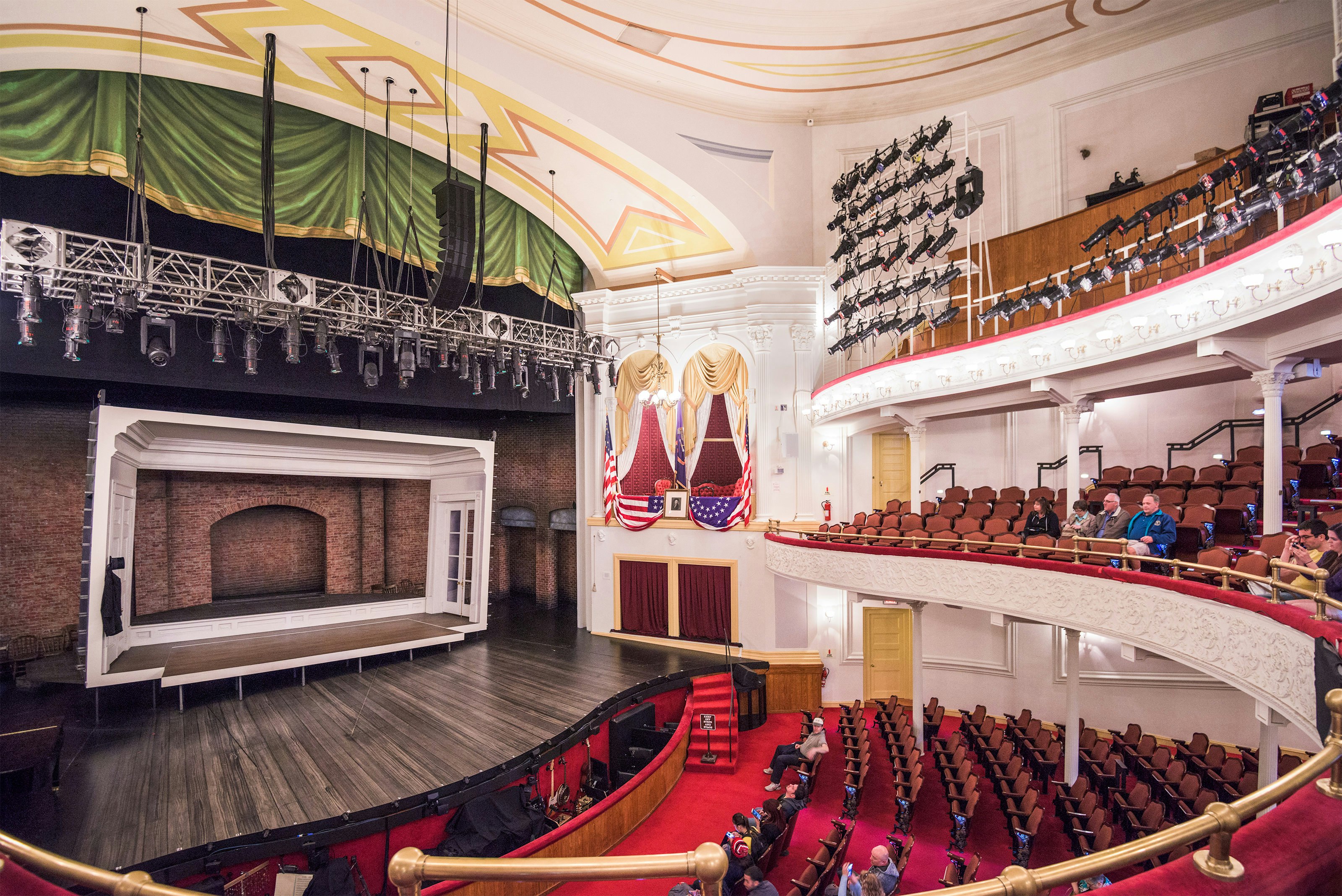 A multi-storied 19th century theater with red seats