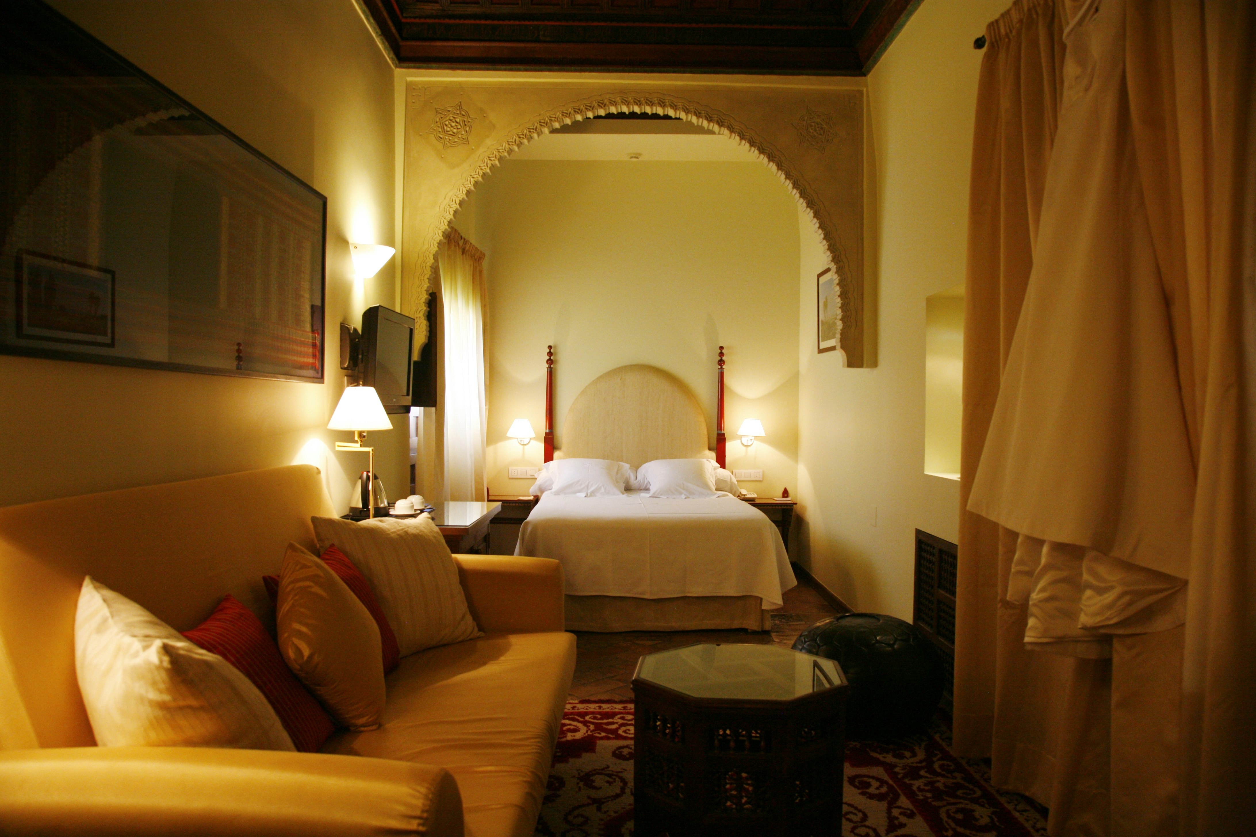 A hotel suite decorated in warm and rich colours like oranges and browns