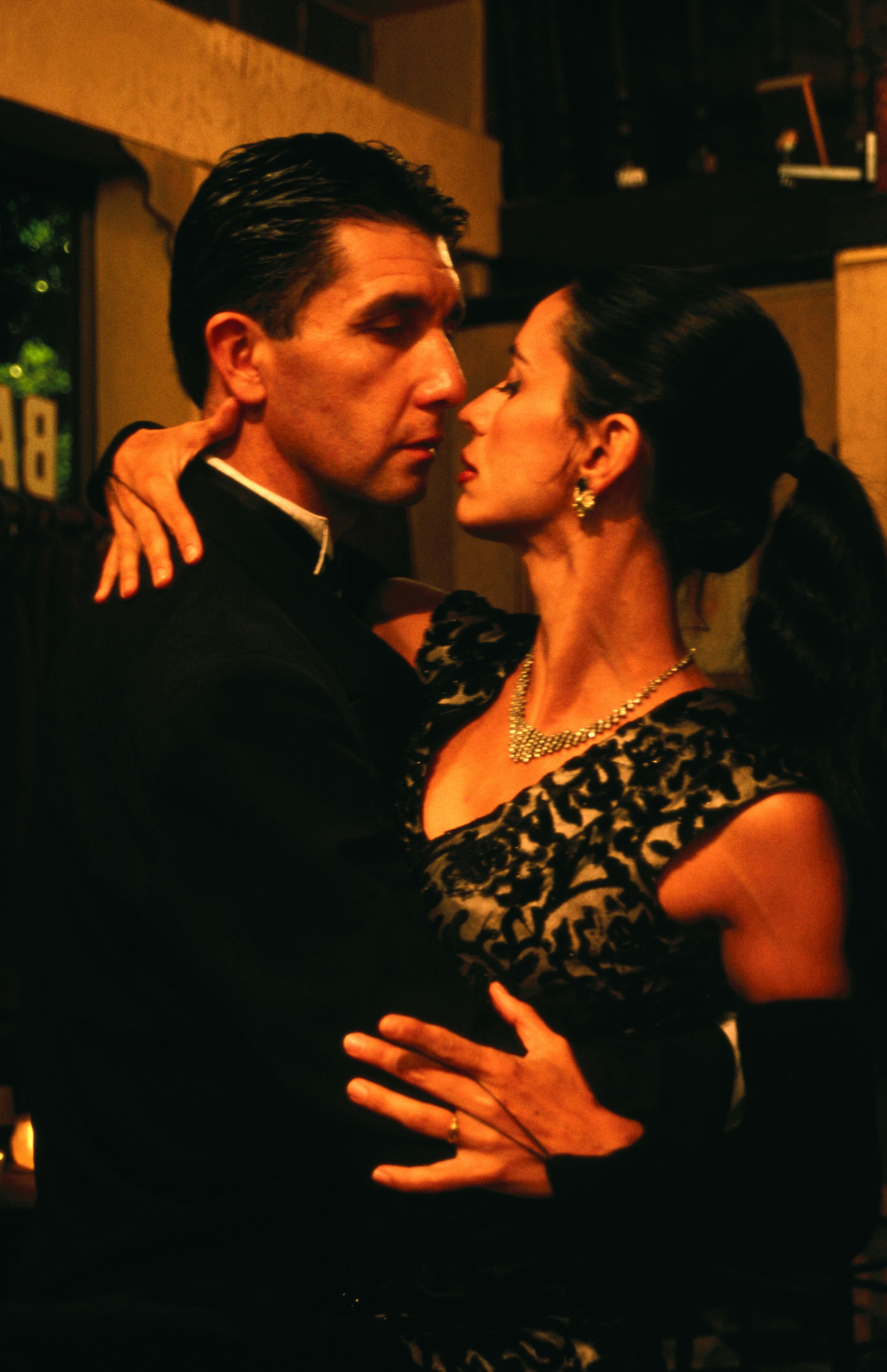 A man and a woman are pressed up against each other, dancing the Argentinian tango in Buenos Aires.