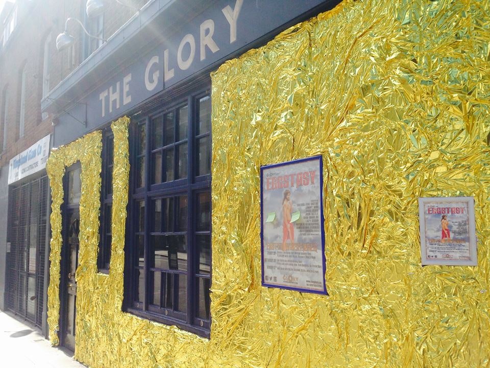 The facade of The Glory, with a glittery gold wall.