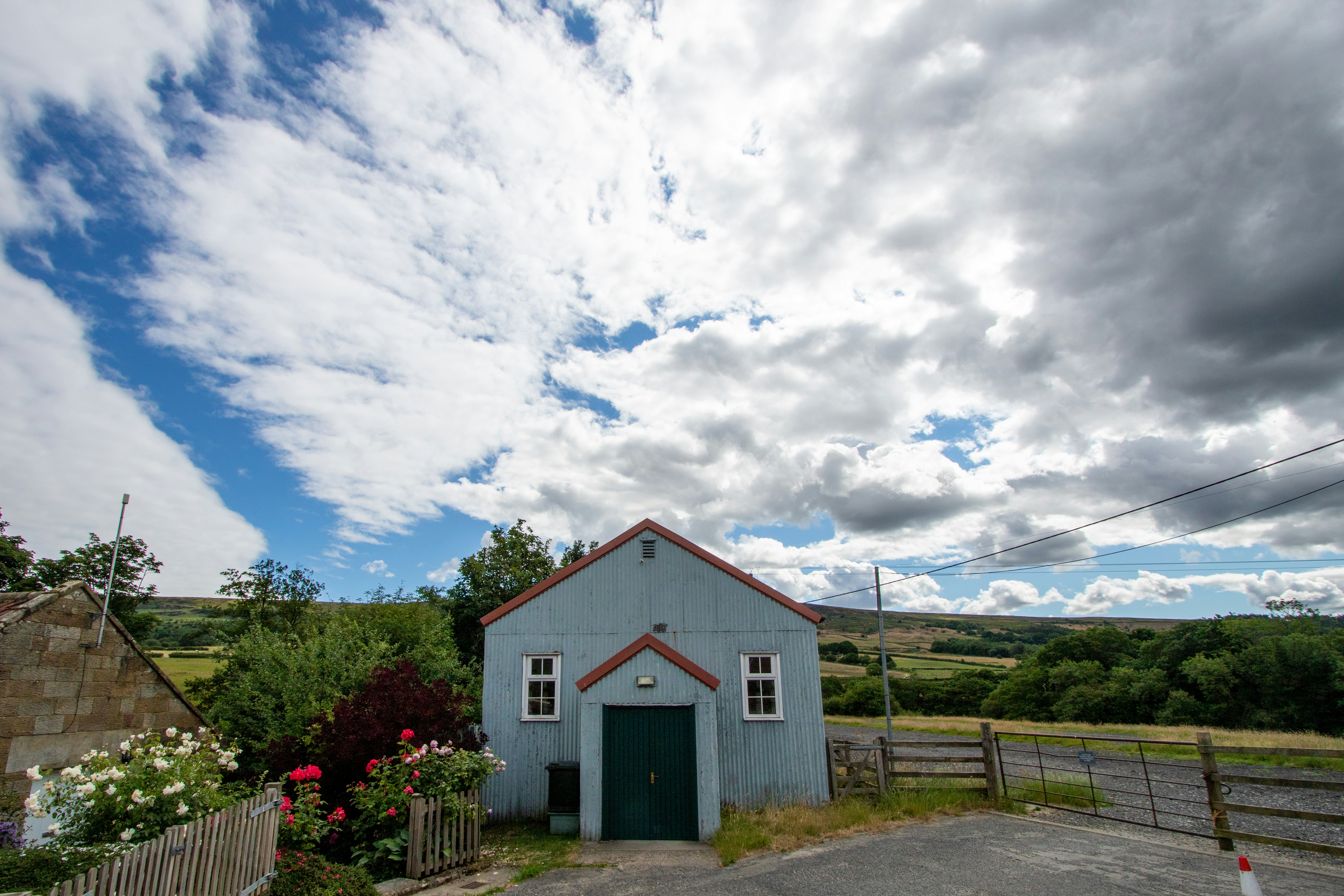 Image of The Band Room, a simple shed on a country road surrounded by the North York Moors.