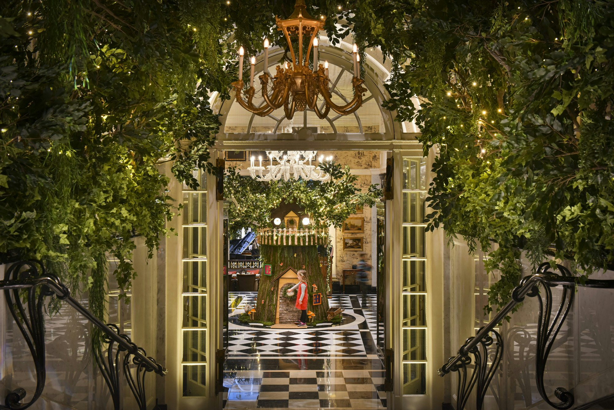 A child gazes in wonder at a LEGO sculpture inside The Savoy London Hotel