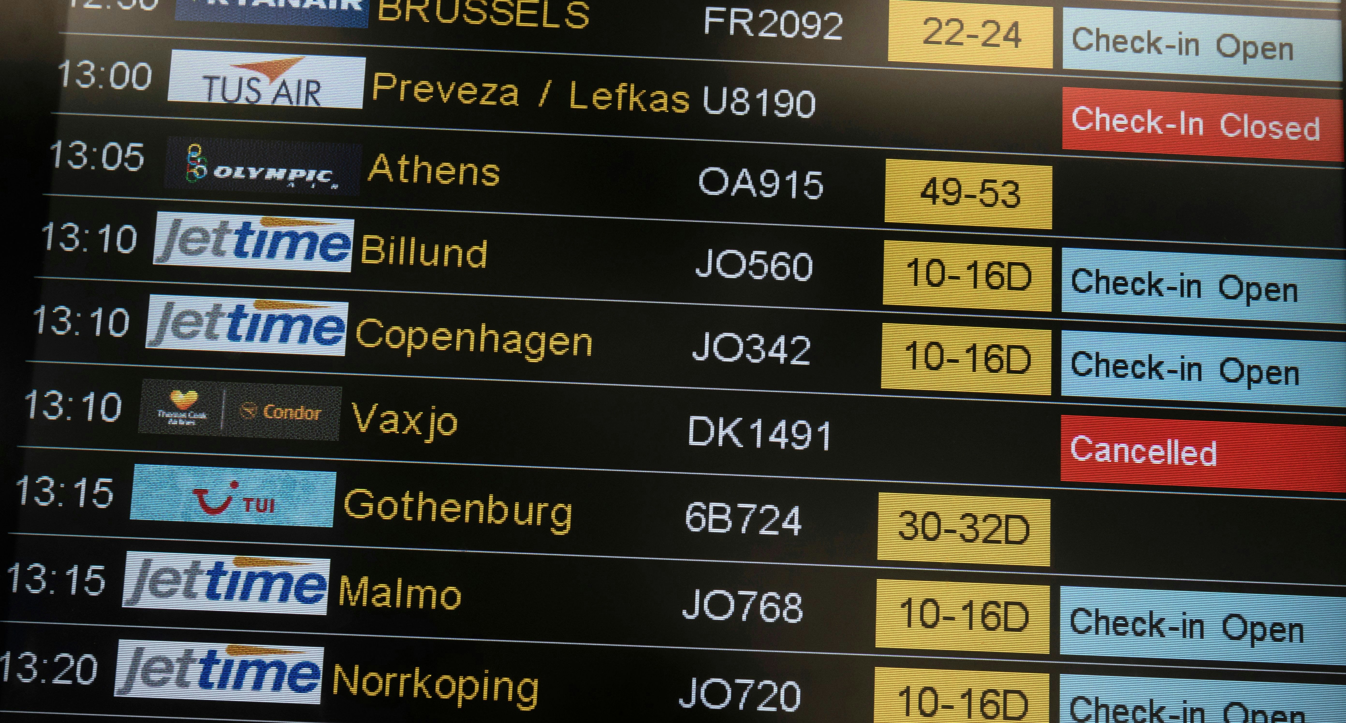 A screen shows the cancelled flights on an airport board. 