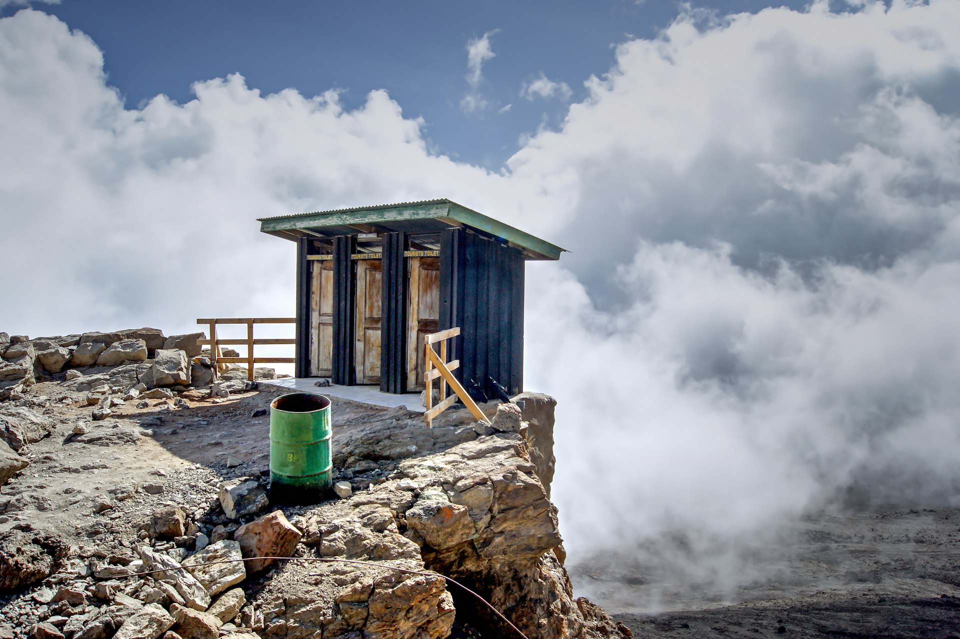 A toilet precipitously perched on the edge of a cliff