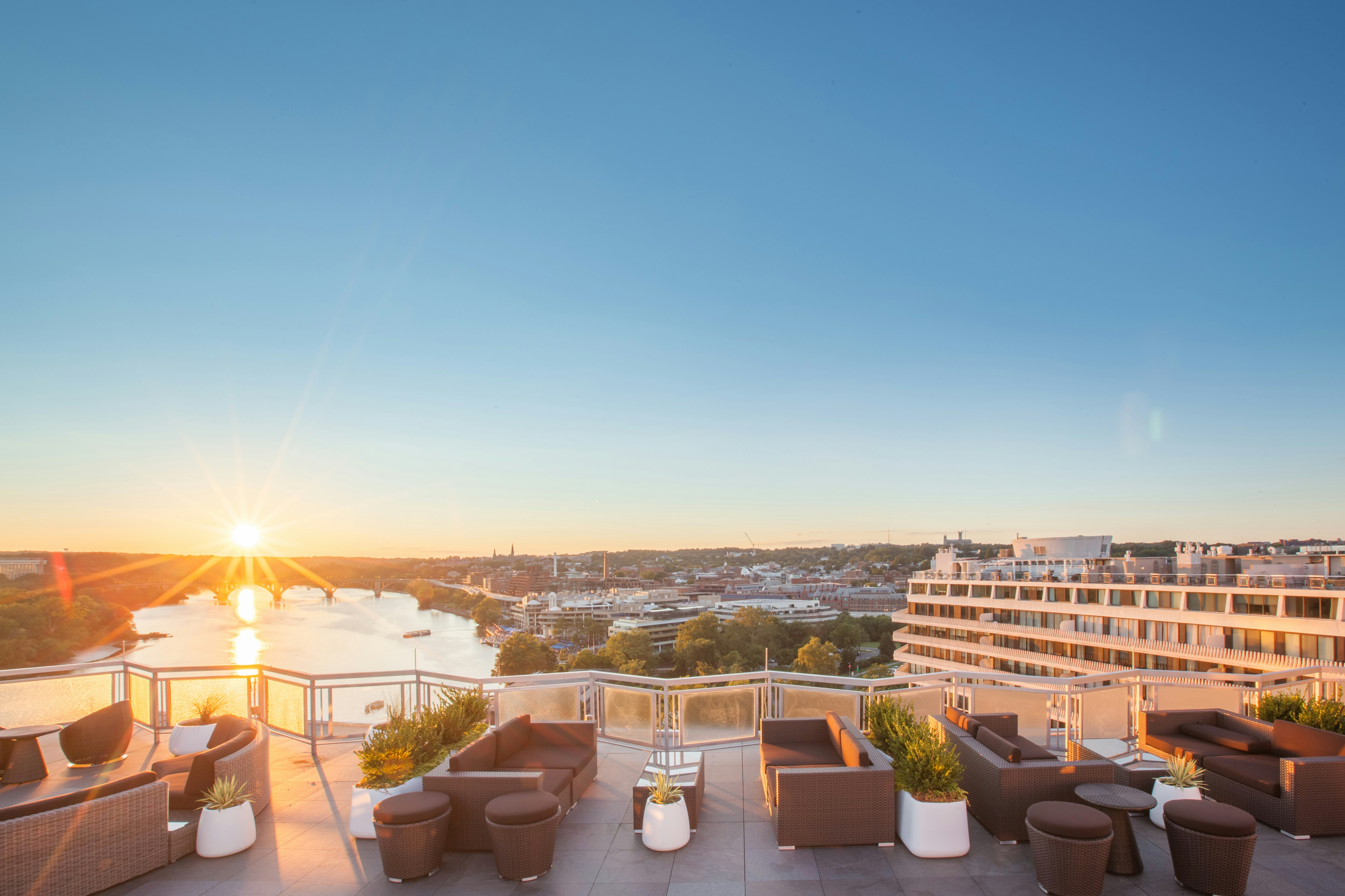 A sunset view looking out onto the Potomac River from the terrace of Top of the Gate rooftop bar.