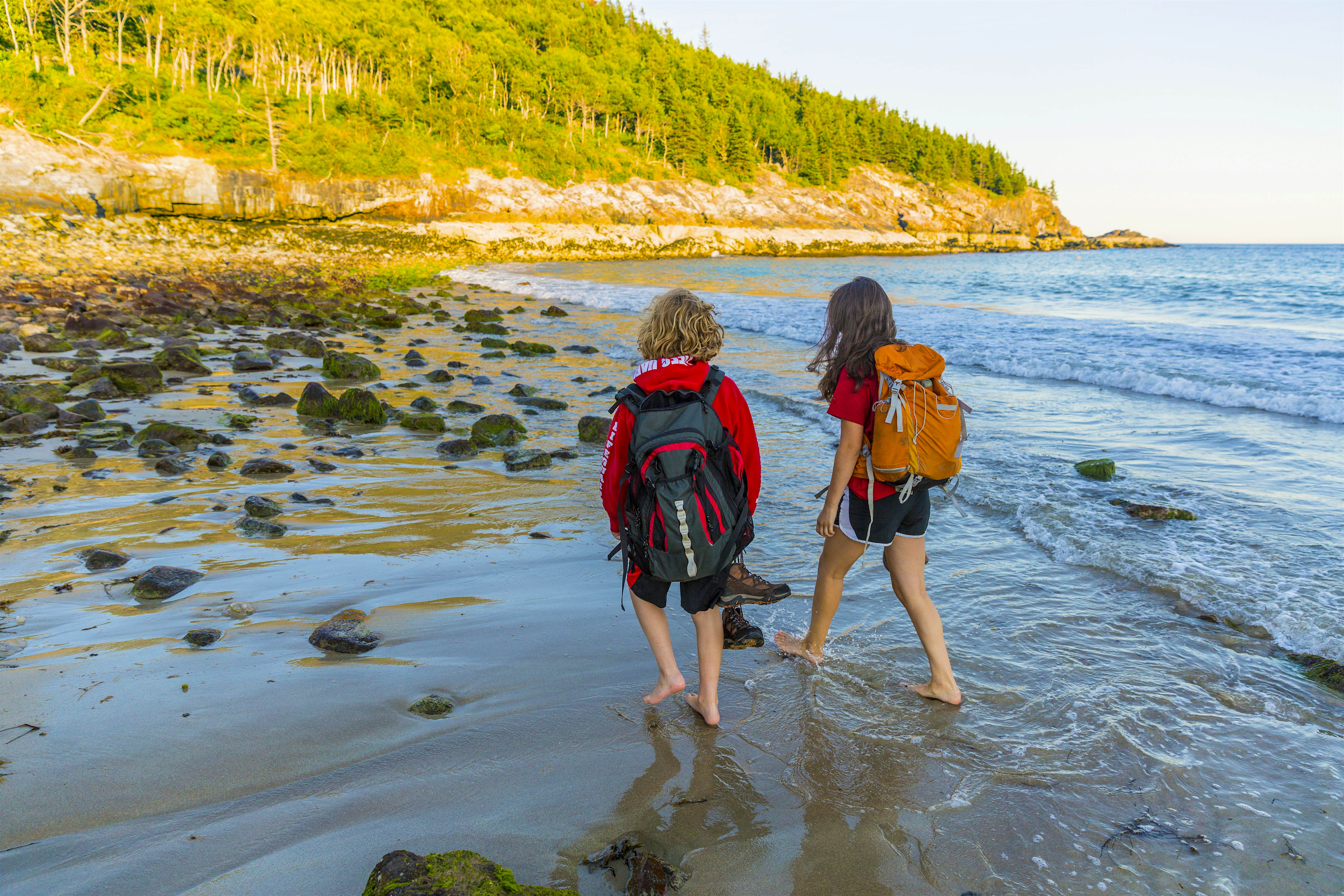 two kids walking through shallow water.jpg two kids walking through shallow water.jpg
