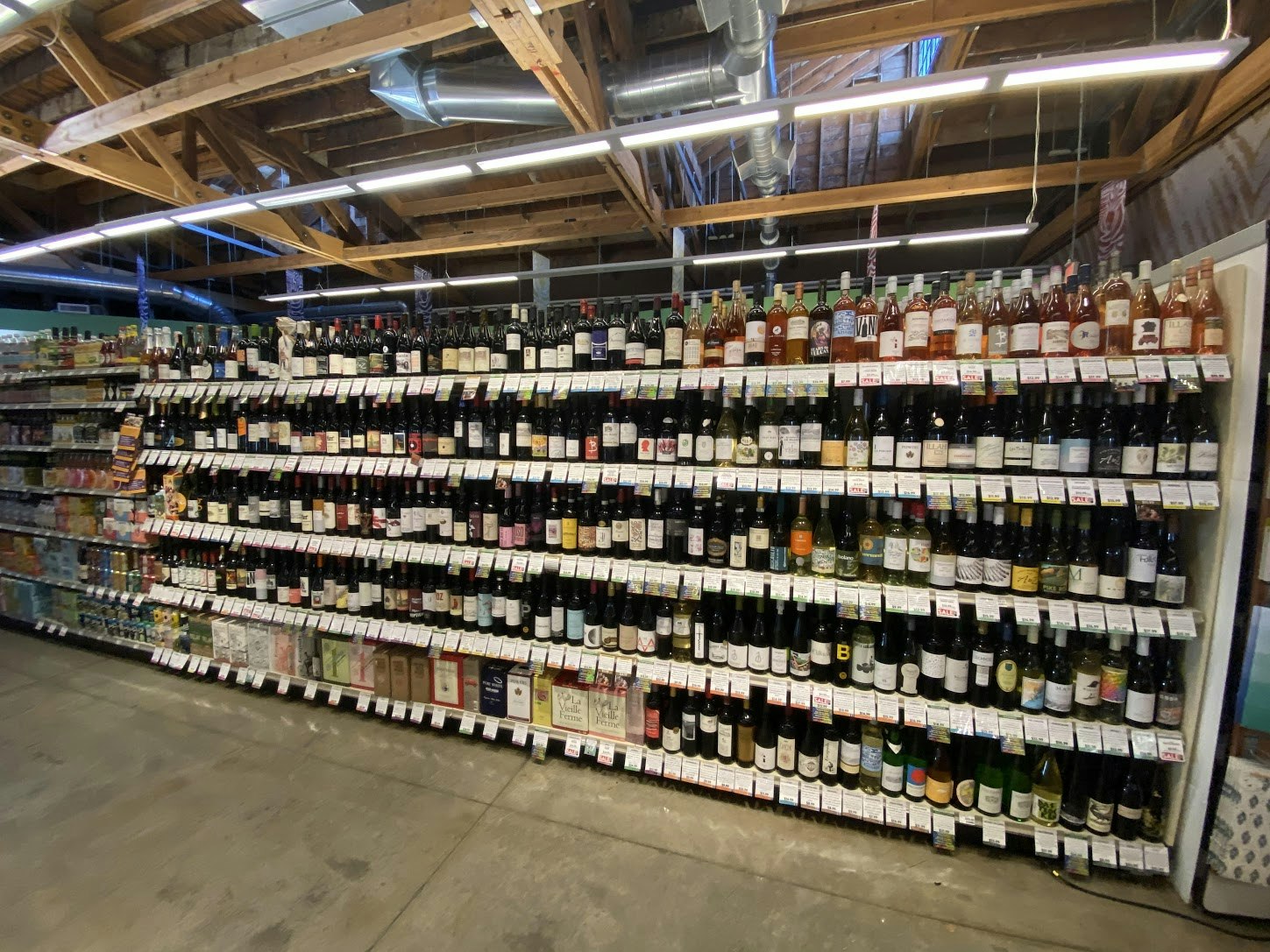 A row of wine bottles from the beverage aisle of a Green Zebra grocery store in Portland, Oregon