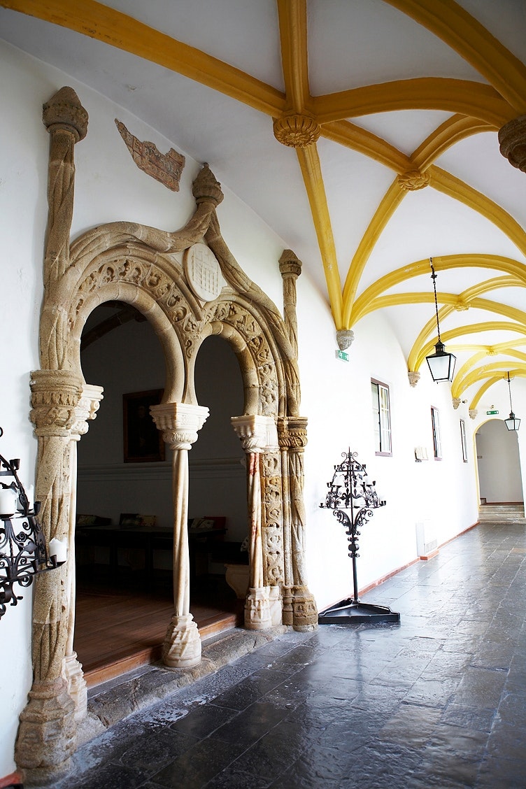 A ornate stone entrance with candelabras at each side.