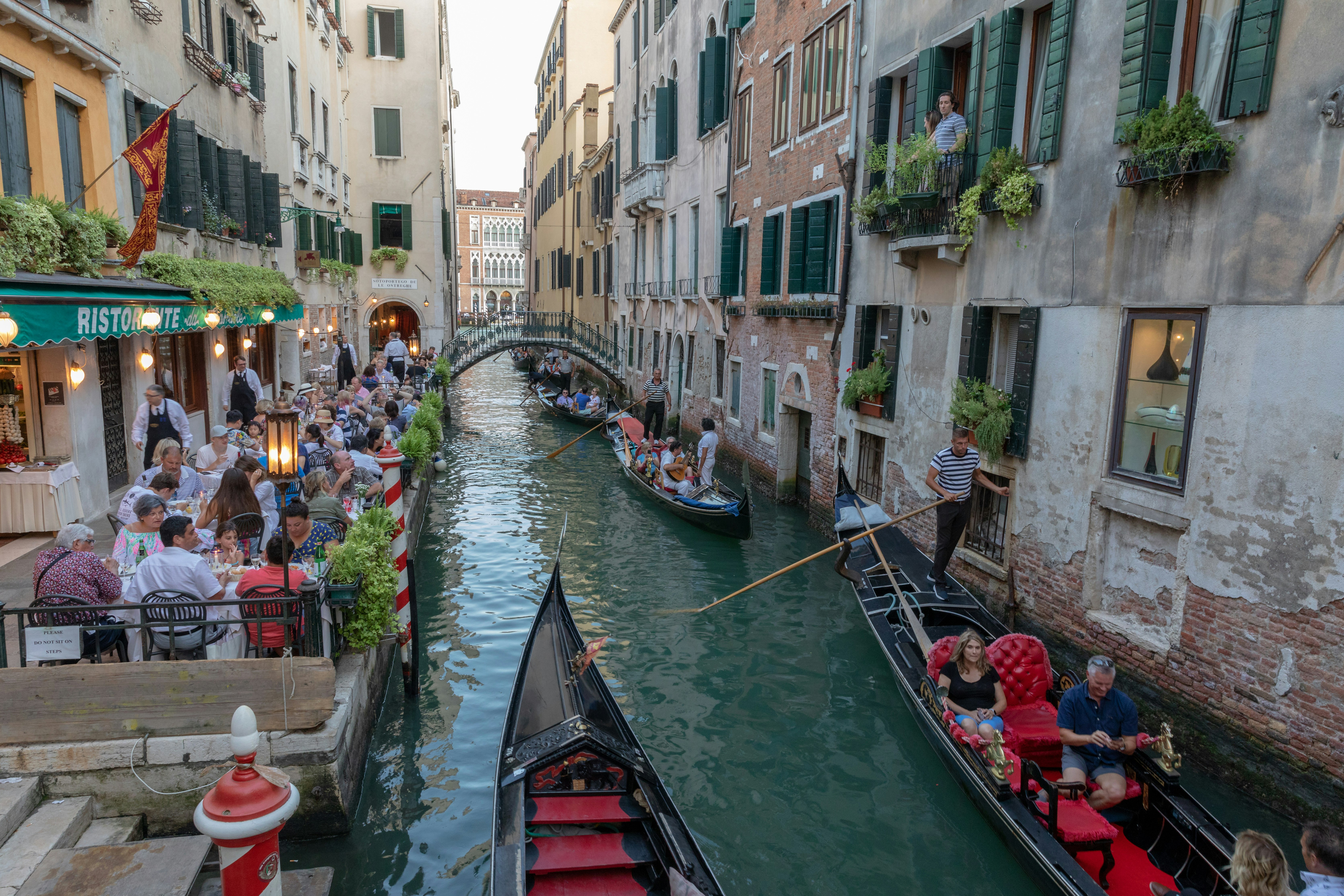 A picture of a narrow Venice canals with gondolas
