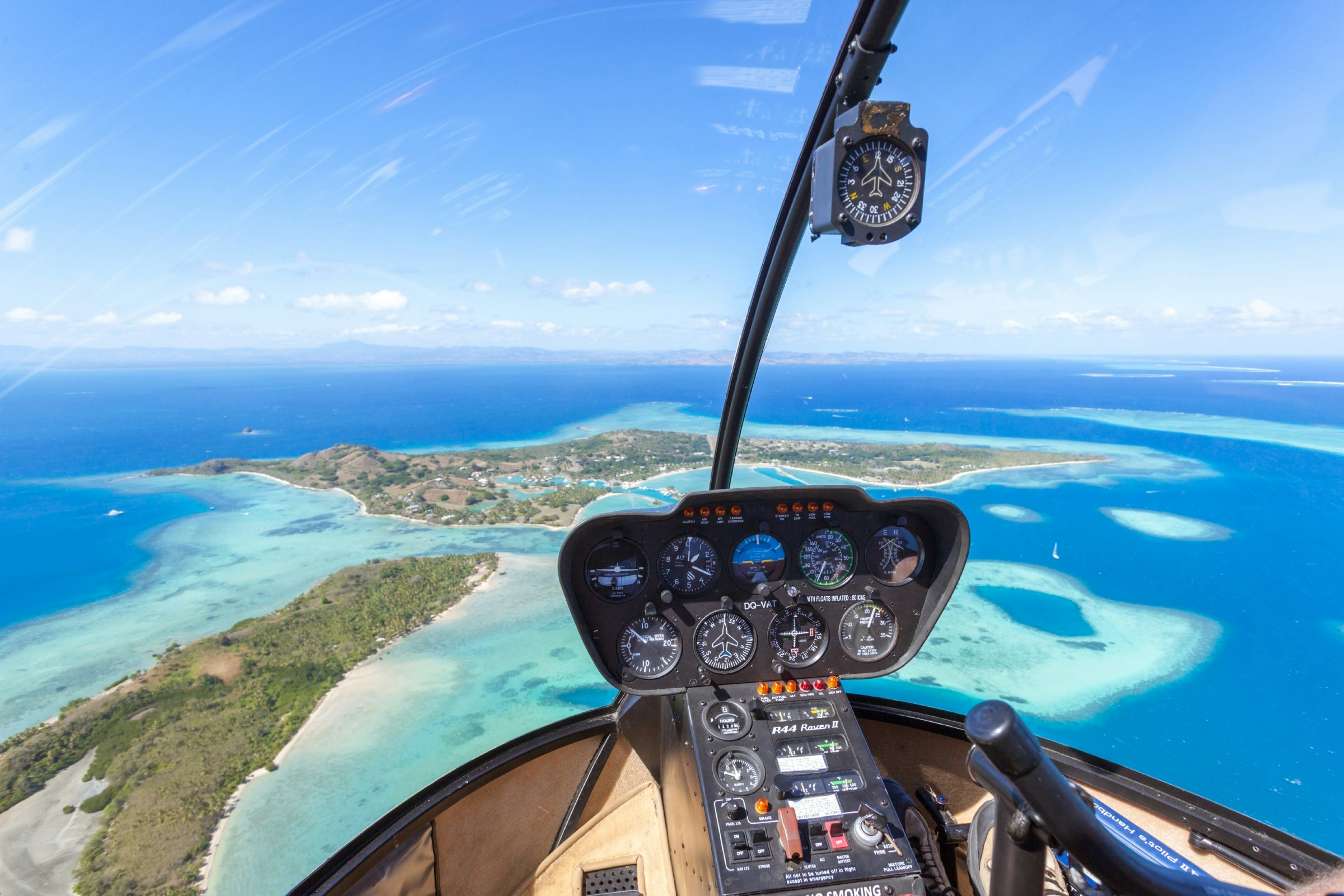 Tropical island seen from helicopter cockpit, Malolo Island, Fiji