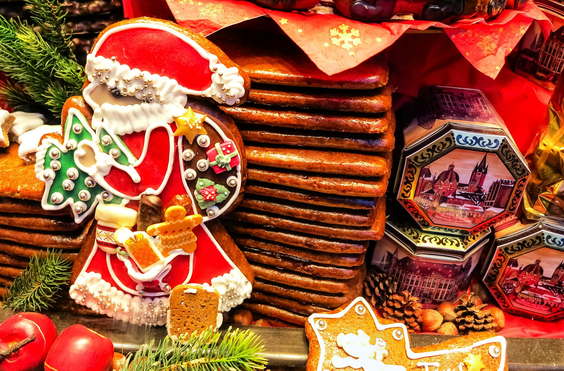 Stacks of Lebkuchen next to a gingerbread Santa Claus