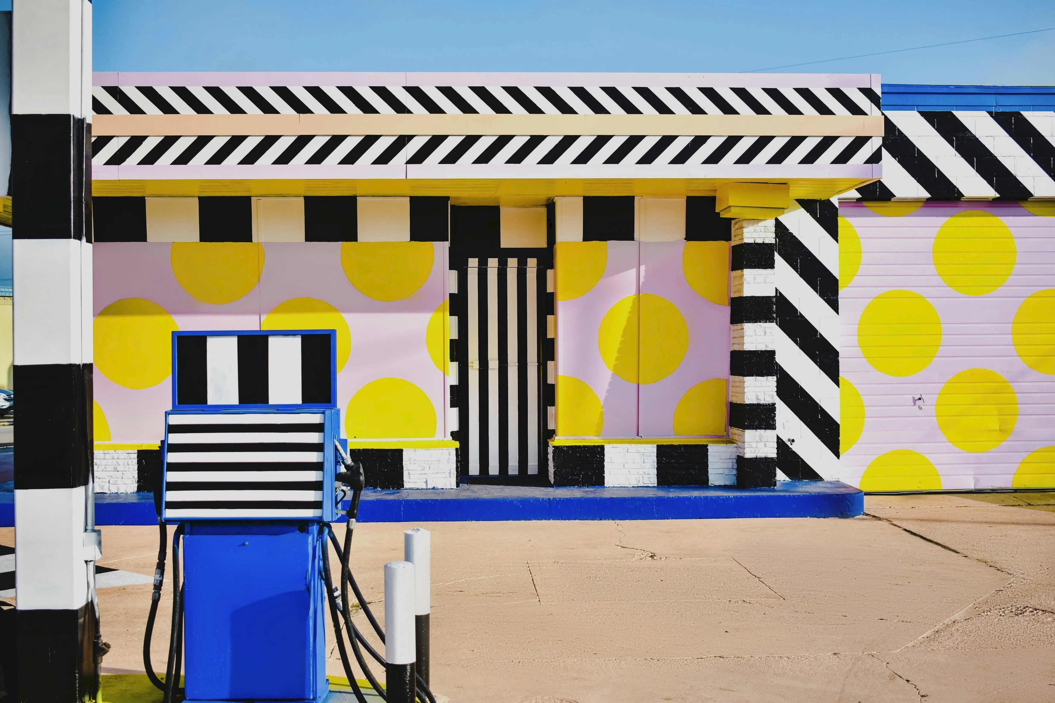 A detail of the gas pump, with a pattern of black and white stripes and yellow polka dots