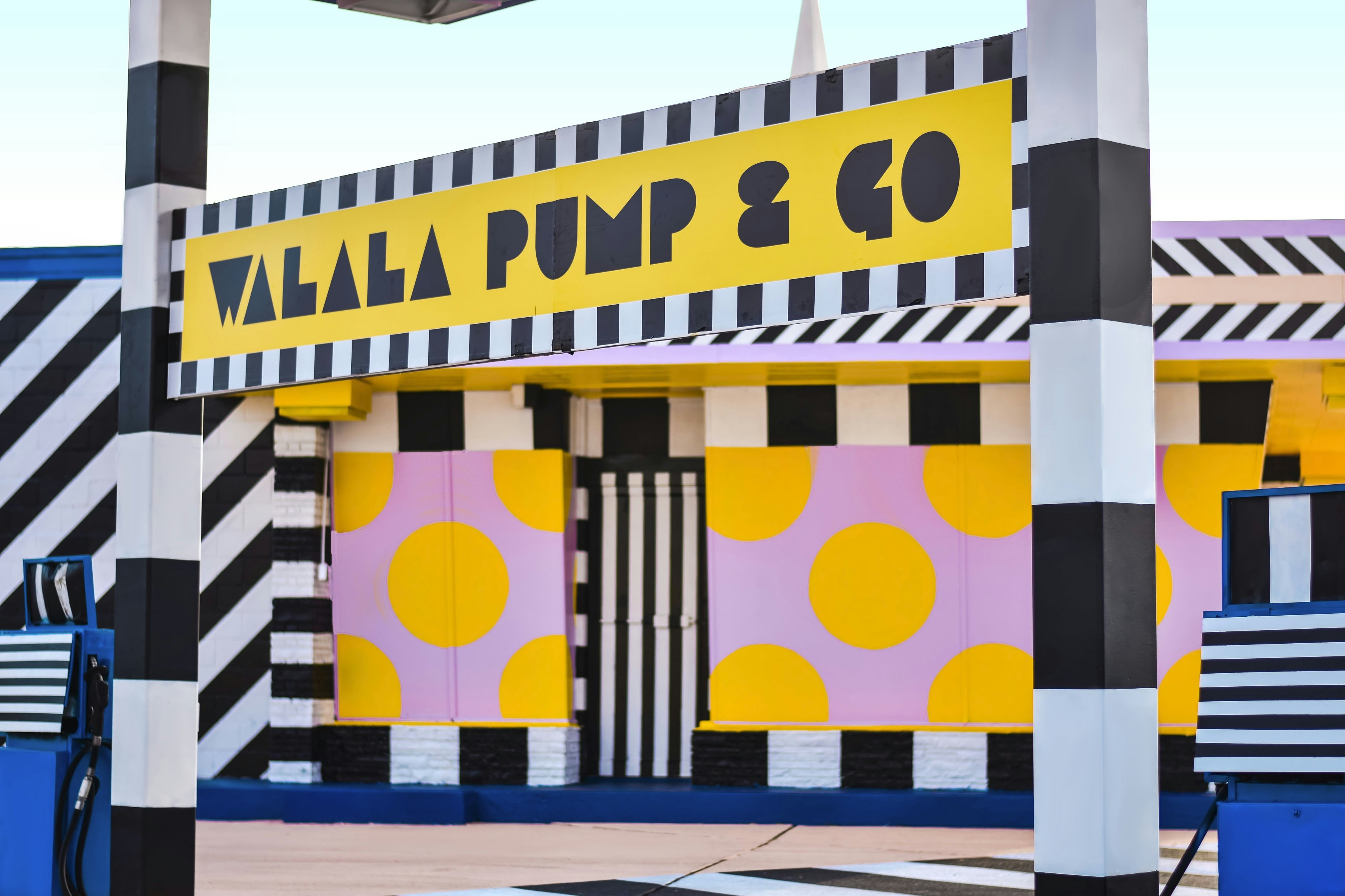 The sign of the Walala Pump&Go, painted black on yellow