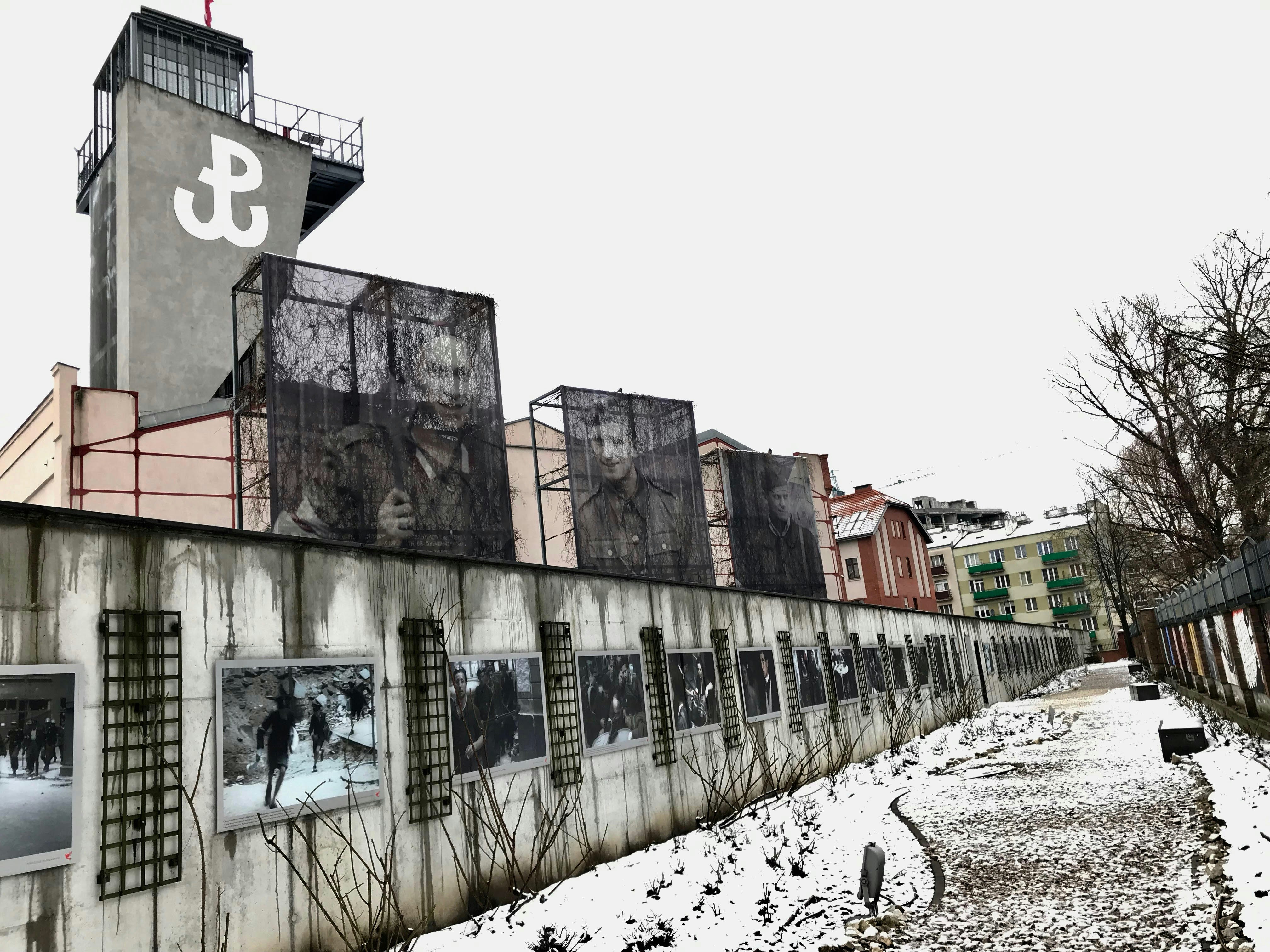 A historic wall is lined with artwork.