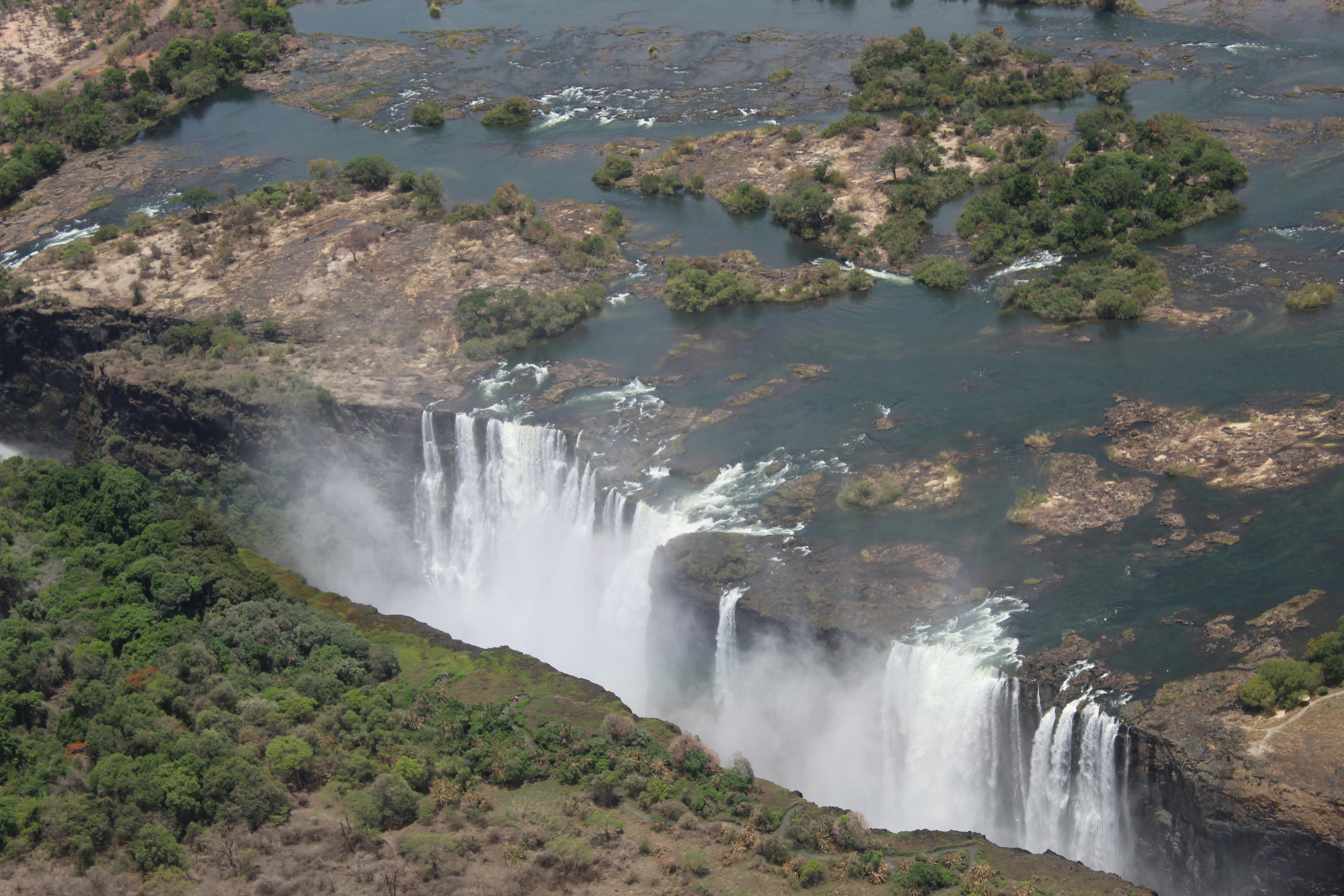 An aerial photo taken by the Zambezi Helicopter Company on December 9th, 2019 shows several columns of white water spilling over Victoria Falls in Zimbabwe