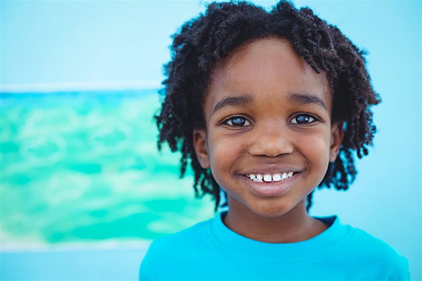 Kids Blog - shutterstock_339727109 A young boy smiles directly at the camera