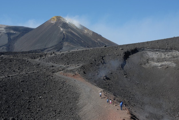 Tourists explore the slopes of Mt Etna.