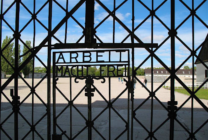 Travel News - Dachau gate The wrought iron gate leading into Dachau reading 'work makes free'.