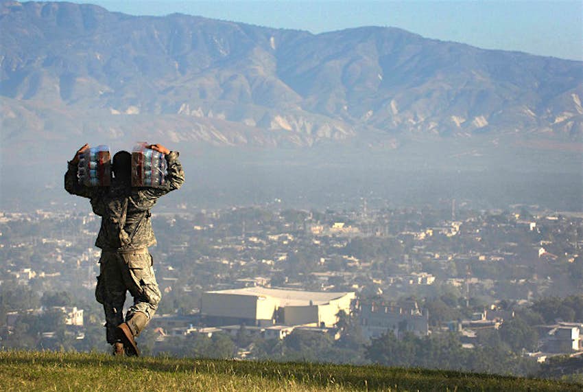 Travel News - Haiti U.S. soldier distribute water in Haiti.
