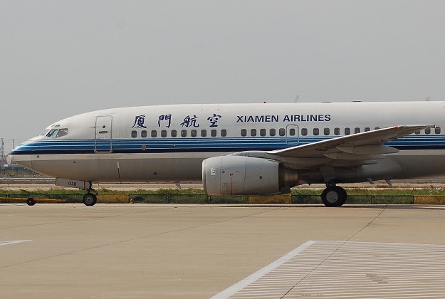 Xiaman Airlines passenger open's emergency door for some 'fresh air'.