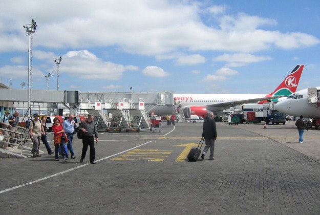 Tourists board a plane at Jomo Kenyatta International Airport.