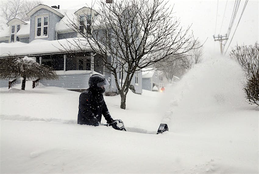 Travel News - bigmass1 John Slasell wades through waist-deep snow as he snow blows the sidewalk along Slater St. in Webster, Mass.