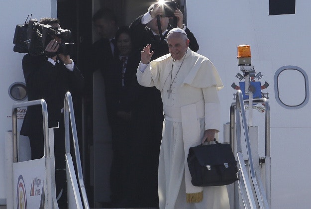 Pope Francis waves goodbye as he leaves Manila