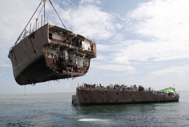 The bow of a US ship is hoisted up after it ran aground on the Tubbataha Reef.