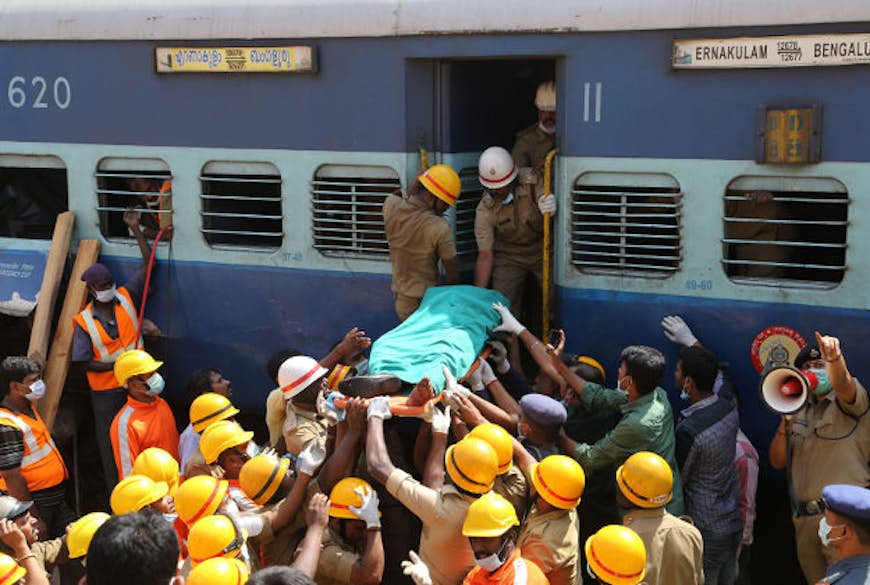 Rescuers carry body of a victim of a train that derailed near Anekal, about 40km south of Bangalore.