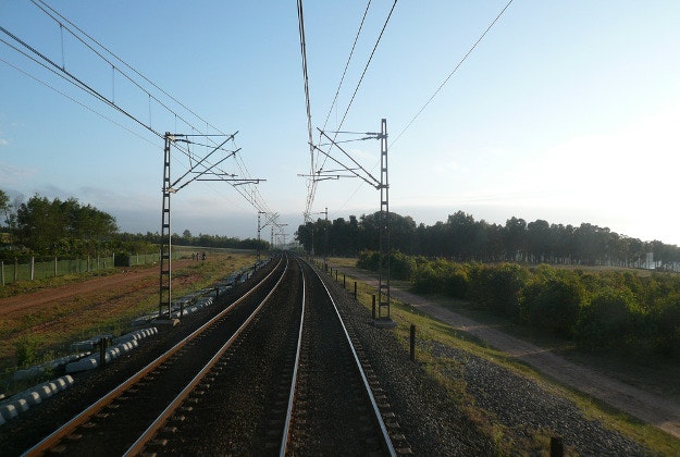 Driver returns to empty track as his train rolls away.