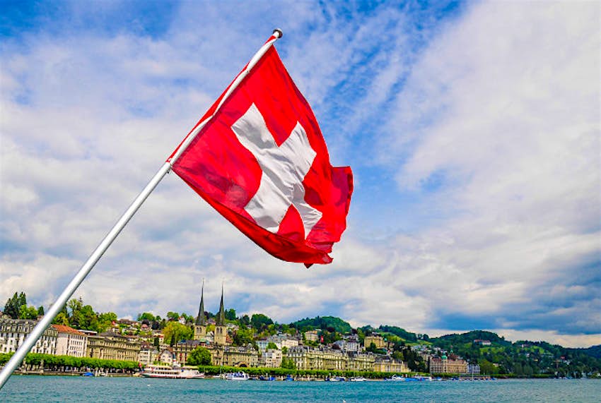 Travel News - Swiss flag Switzerland voted world’s happiest country.