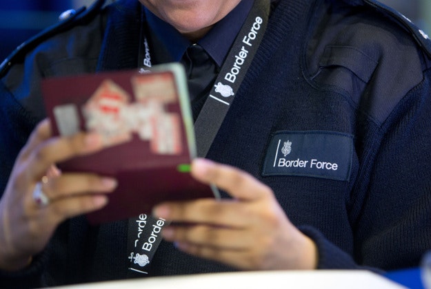 Border Force officer checking passports of in Terminal 2, The Queen Terminal, at Heathrow Airport, as passport checks on travellers leaving Britain are being brought in.
