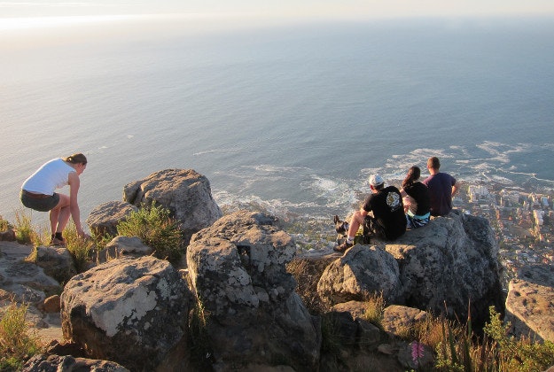'Dare devils' sit on the edge of Cape Town's Lion's Head.