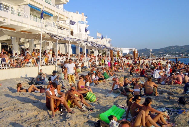 Crowds soaking up the sun on an Ibiza beach but but for some living in 5-star accommodation there is a daily charge of €2 per day from yesterday
