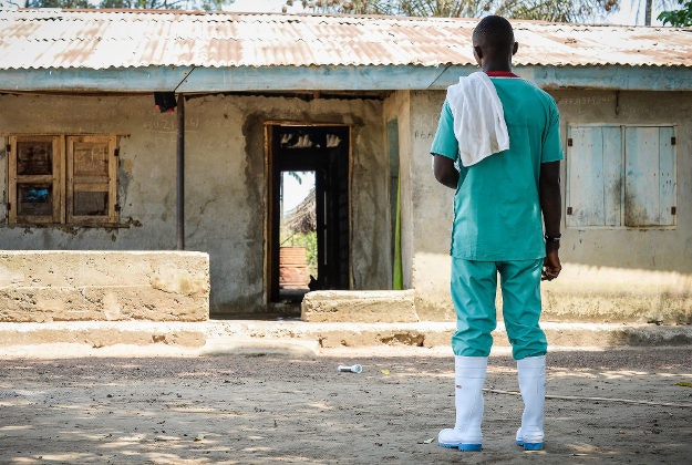 An Ebola relief worker decontaminating houses in Makamie, Sierra Leone.