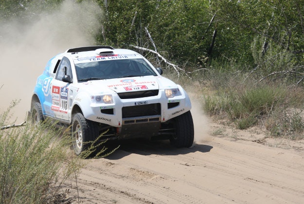 A competitor kicking up dust on the Silk Way rally.