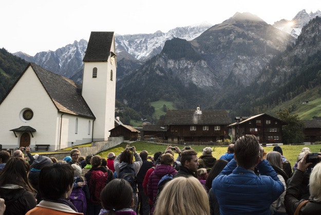 People watch the sun shining through "Martinsloch" (Martin's Hole) in Switzerland on Wednesday.
