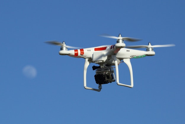 A flying drone with a mounted camera.