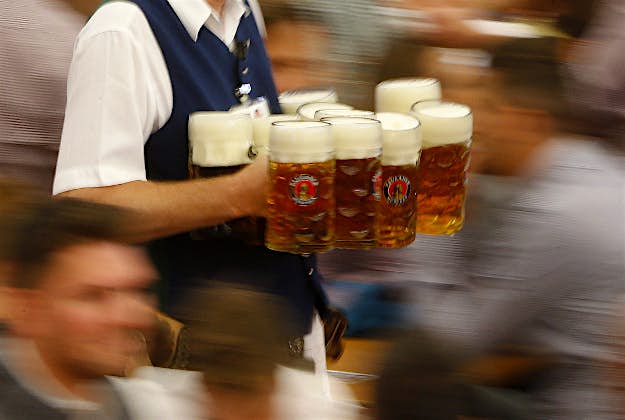 Travel News - oktoberfest bavaria 2 A waiter carries beer mugs during the opening of the 182st Oktoberfest beer festival in Munich, southern Germany,