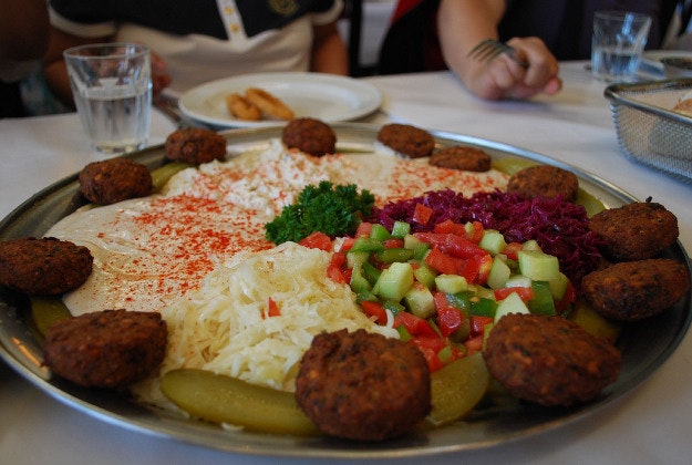 Hummus bar in Israel offers half price meals to show 'we're all human beings'.