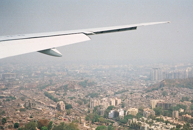 A plane flies over India.