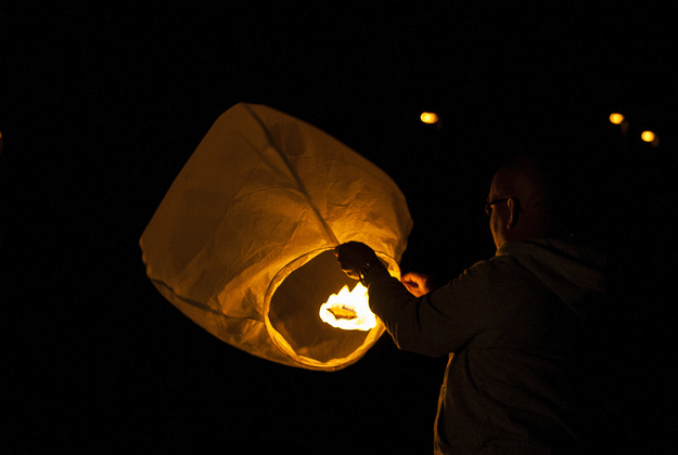 Paper lanterns light up the night sky.