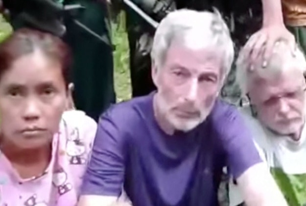 his frame grab from militant video purportedly shows armed militants surrounding two Canadians, a Norwegian and a Filipino woman abducted last month in the Philippines. 