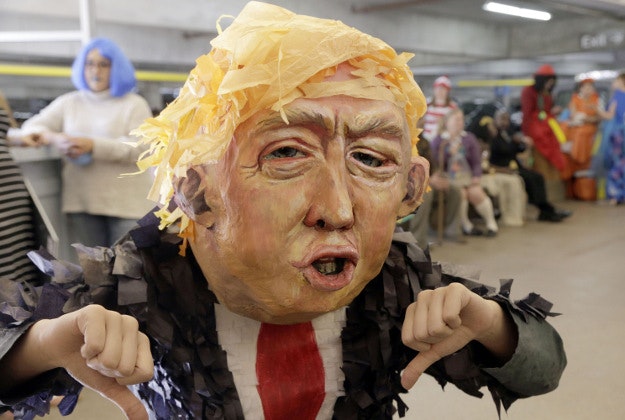 Alia Yusuf wears a "Donald Trump" mask before the taping of a Halloween themed television show. 