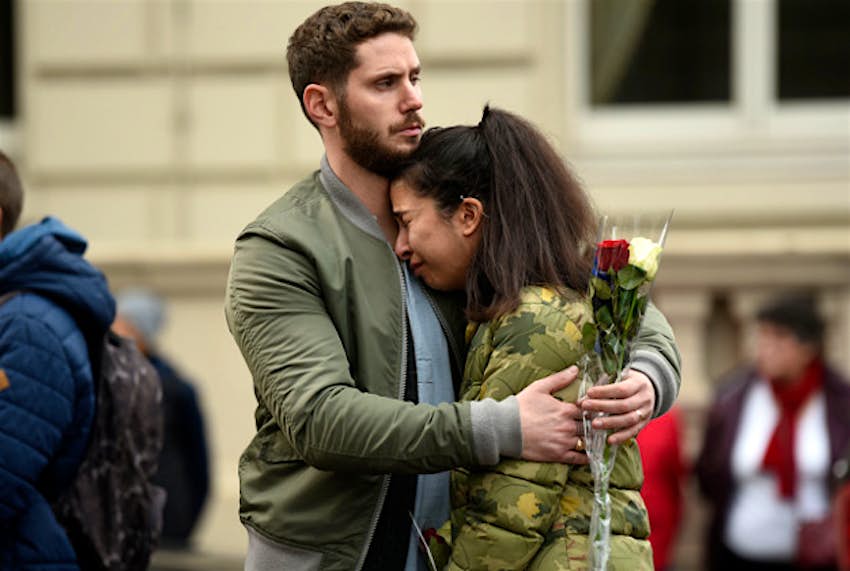 Travel News - London A couple hug in Trafalgar Square, London during an observed minute of silence