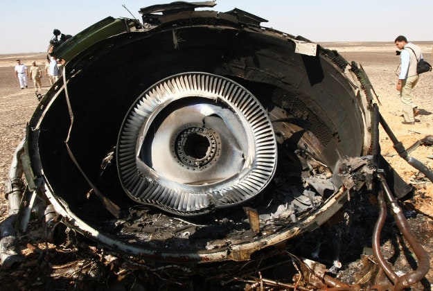 Egyptian Military experts examine a piece of an engine at the wreckage of a passenger jet bound for St. Petersburg in Russia that crashed in Hassana, Egypt, on Sunday, Nov. 1, 2015. 